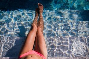 Body of beautiful woman. Girl relaxing in a poll at summer