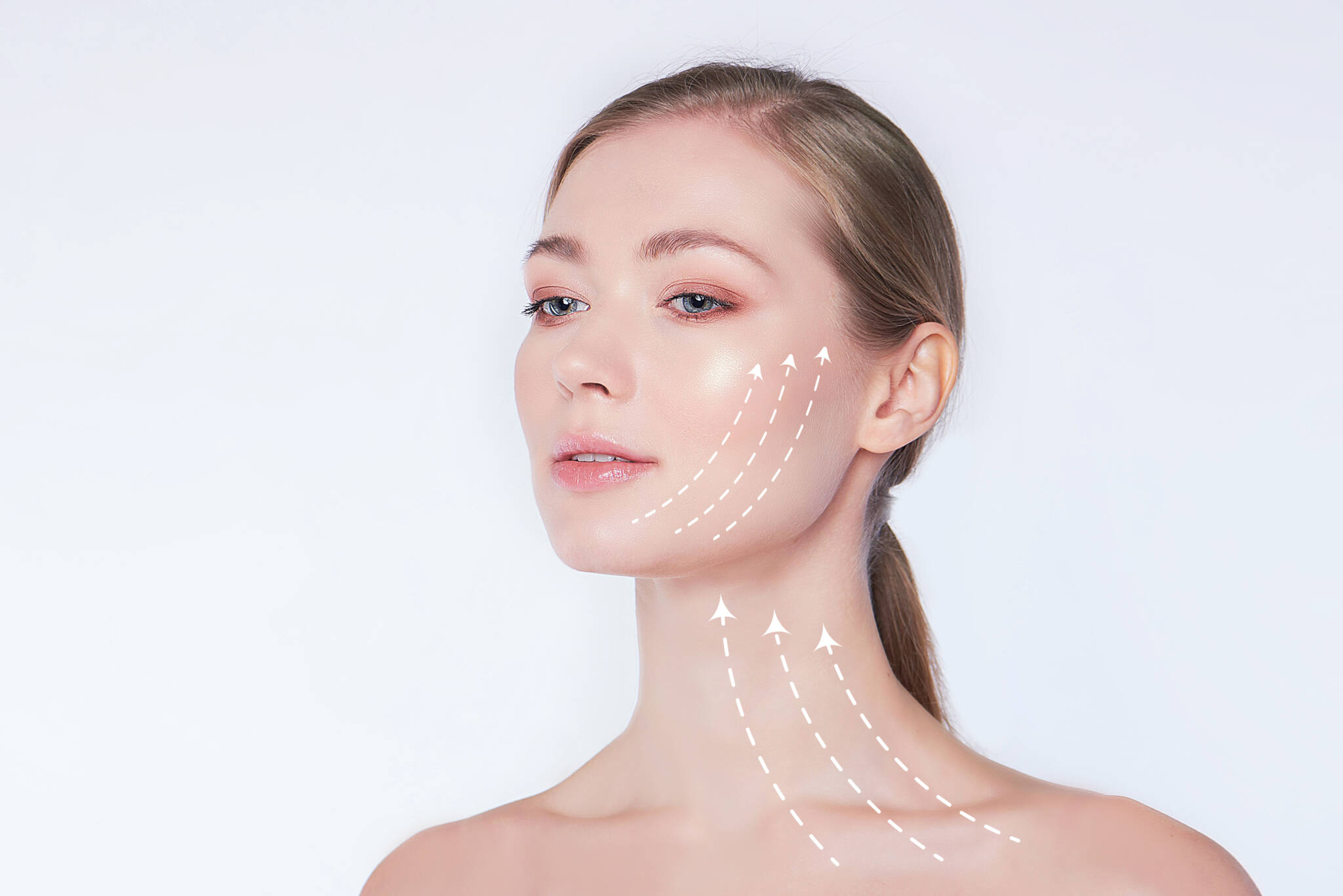 Beautiful young woman with white arrows on face and neck